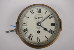 A mid C20th brass cased Smiths eight day bulk head ship's clock, 17cm diameter, AF glass chipped