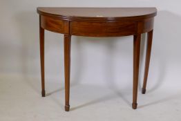 Georgian mahogany demi lune tea table, with crossbanded top and inlaid stringing, raised on square