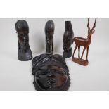 Three African carved ebony heads, 23cm high, a carved hardwood mask and a carved antelope