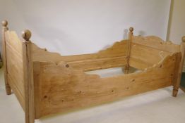 An antique pine single bed with panel head and footboards, 86 x 97 x 188cms
