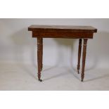 A C19th mahogany fold over tea table on ring turned supports and brass castors, 74 x 89 x 44cms