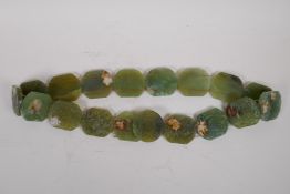 A Chinese green hardstone belt with carved phoenix decoration, 100cm long