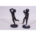 A pair of bronze figures of putti playing the triangle and cymbols, unsigned, 23cm high