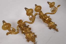 A pair of ormolu two branch wall sconces, decorated with floral swags, fruit and figure busts, 26