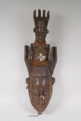 An antique African carved wood mask with a fabric bound figural surmount, possibly West African,  20