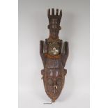 An antique African carved wood mask with a fabric bound figural surmount, possibly West African,  20