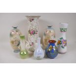 A rose decorated porcelain trumpet vase, 31cm high, and six other pottery vases