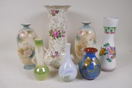 A rose decorated porcelain trumpet vase, 31cm high, and six other pottery vases