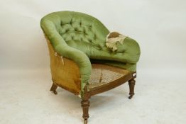 A Victorian walnut tub shaped easy chair with carved seat, raised on turned supports