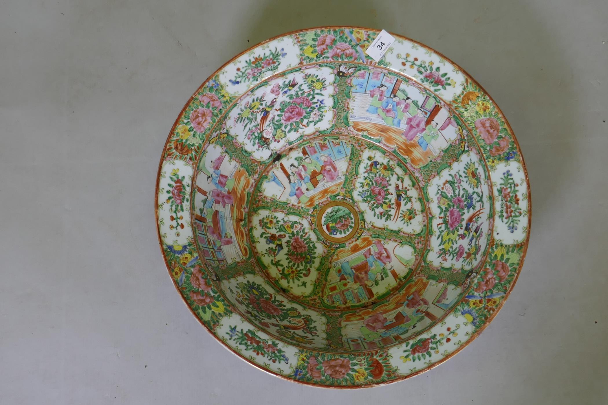 A C19th Cantonese famille rose ceramic bowl, decorated with birds, butterflies and figures, 47cm