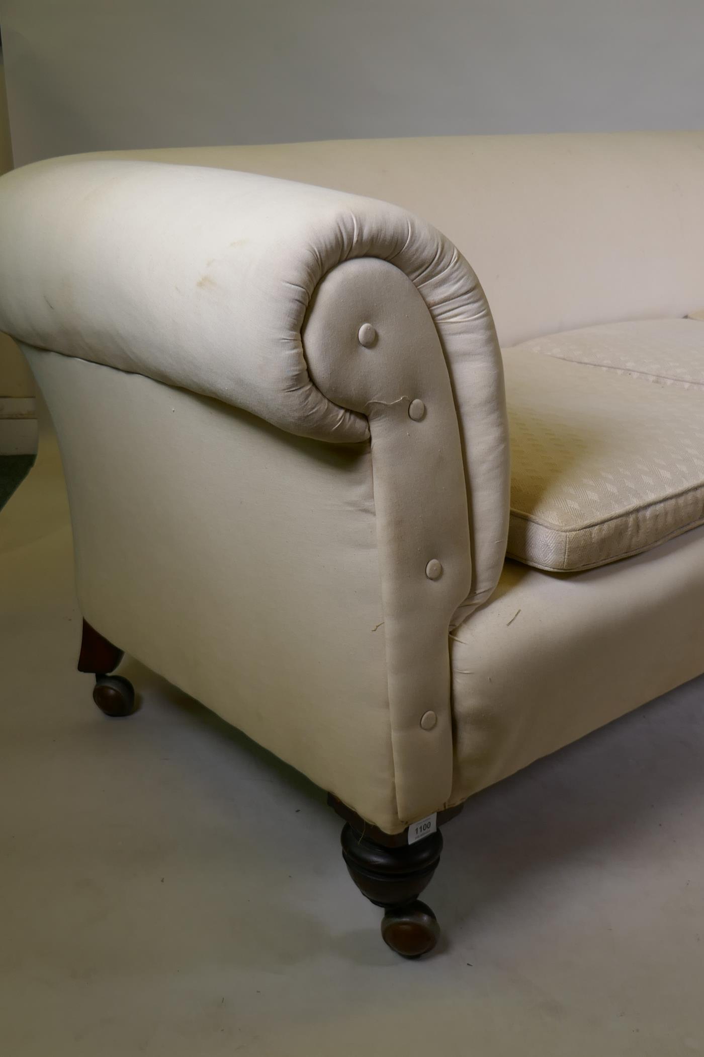 A Victorian Chesterfield settee with calico covers, raised on turned supports - Image 3 of 3