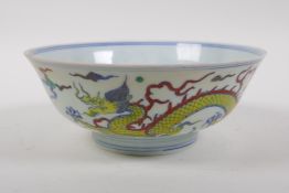 A Doucai porcelain rice bowl decorated with dragons, Chinese Chenghua 6 character mark to base, 19cm
