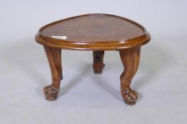 A C19th wood stand with mahogany top, raised on three hyew or fruit wood carved supports, with paw