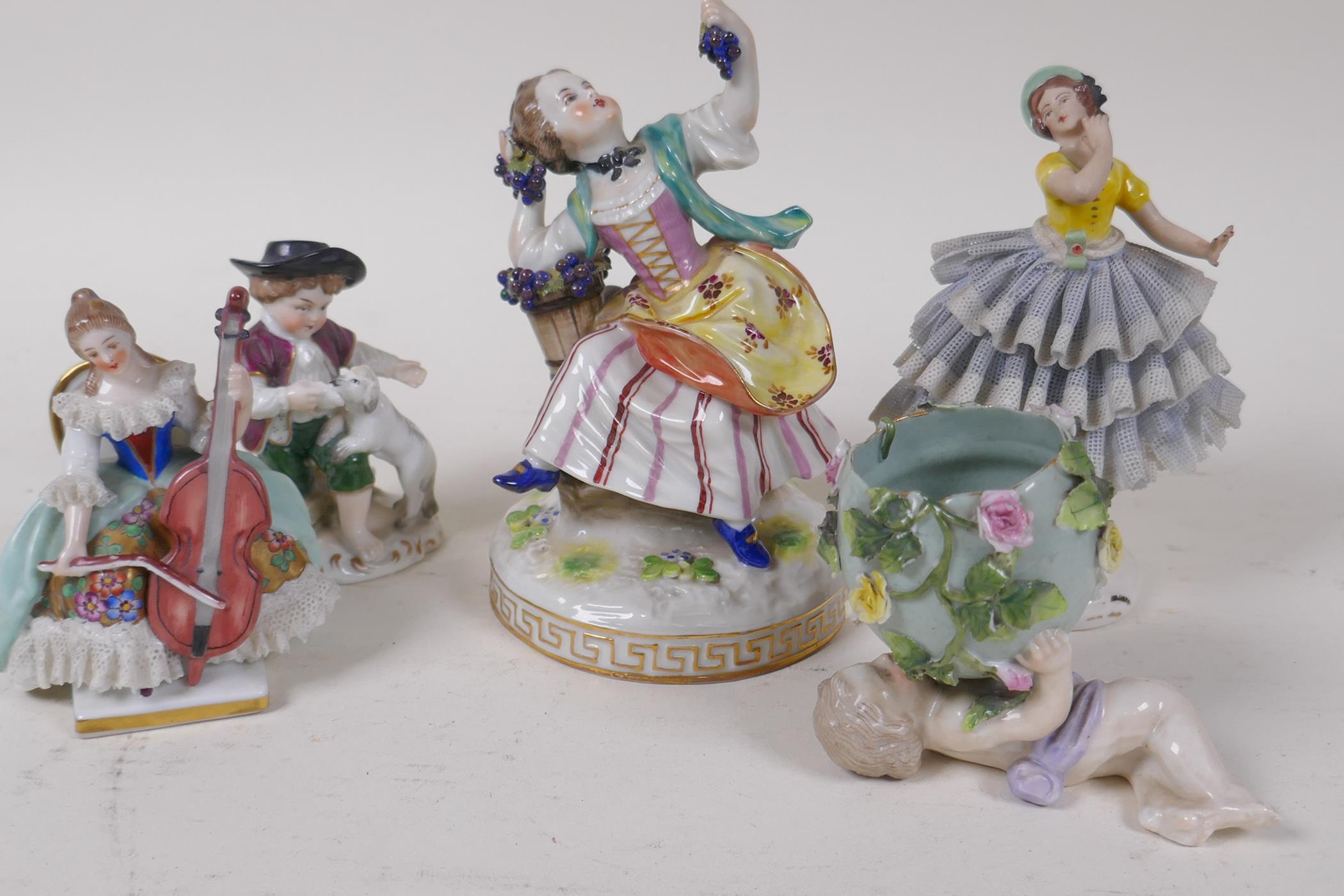 A C19th German porcelain figure of a girl with grapes, 13cm high, and four other continental