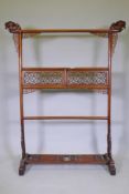 A Chinese carved wood robe rack with decorative pierced panels, 150cm high, 121cm wide