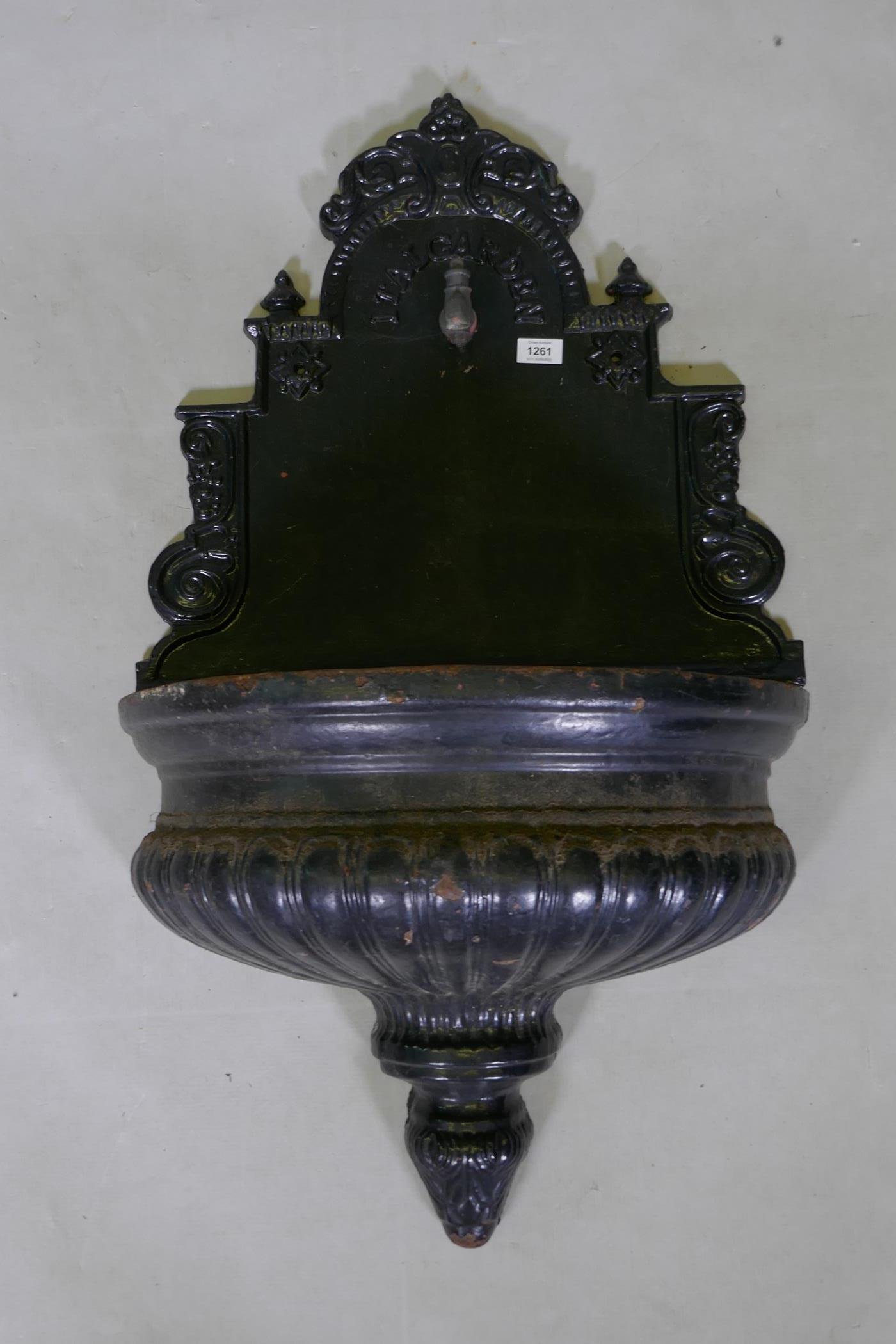 A painted cast iron Ital Garden wall fountain with gadrooned shaped bowl, 58 x 100cms