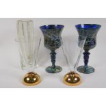 A pair of Polish multi colour pedestal wine glasses, 18cm high, a pair of clear glass flutes on