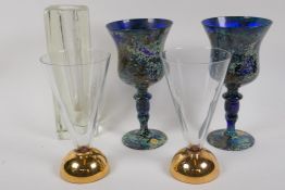 A pair of Polish multi colour pedestal wine glasses, 18cm high, a pair of clear glass flutes on