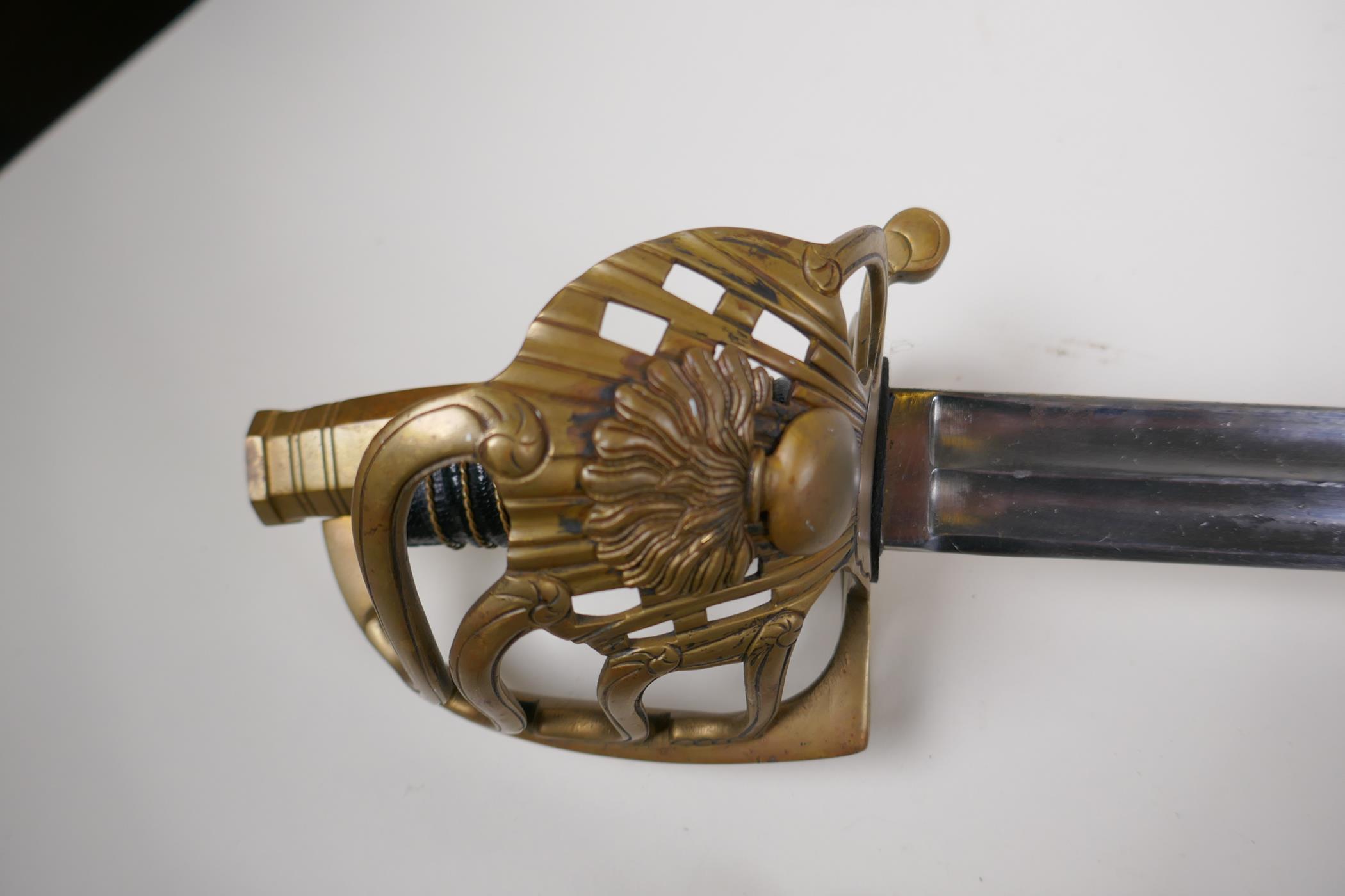 A cavalry sword with brass basket hilt wire round grips and twin fullard steel blade marked Mfture - Image 2 of 5