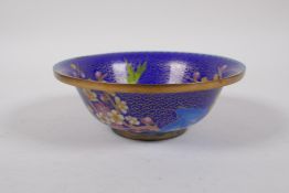 A Chinese blue ground cloisonne bowl with bird and prunus blossom decoration, 16cm diameter