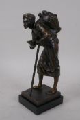 An Orientalist bronze figure of a Moor water carrier, signed indistinctly Kowalczewski ?, with