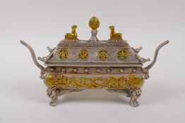 A Tibetan white metal casket shaped censer and cover with dragon decoration and gilt highlights,