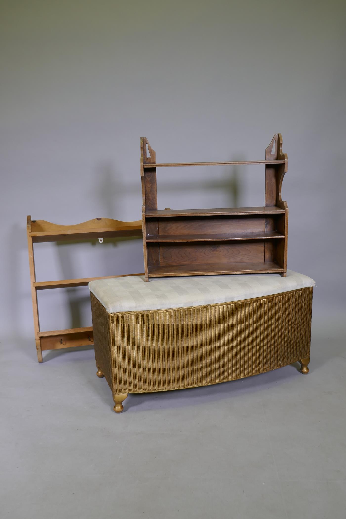 A Lloyd Loom Ottoman with upholstered seat, 90cm wide, and two pine shelf units