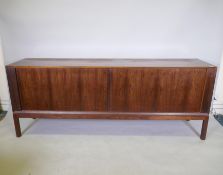 A mid century Danish rosewood sideboard with tambour sliding doors, designed by Aksel Kjersgaard,