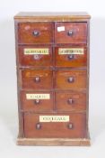 A C19th mahogany apothecary chest comprising a bank of nine drawers with eglomise labels, adapted,