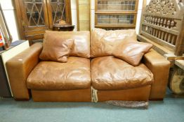 A leather two seater sofa bed, 200cm wide