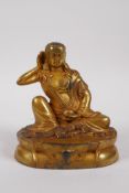 A Tibetan gilt bronze figure of Buddha, impressed double vajra mark to base, 14cm high