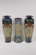 A Royal Doulton Art Nouveau stoneware vase, and a similar pair of Doulton vases, 1 foot AF, both