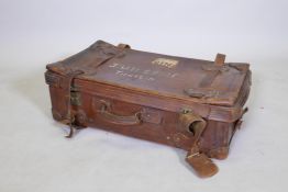 A vintage brown leather suitcase with brass catches and locks, for restoration, 78cm wide