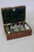 An early C19th rosewood vanity case with brass mounts and inlay, the interior fitted with silver