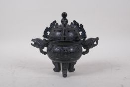 A Chinese soapstone censer and cover with two phoenix head handles and tripod supports, 15cm high,