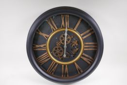 A wall clock with quartz movement and separately powered open cogwork, with bronzed Roman