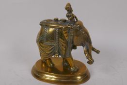 An Indian cast brass oil lamp in the form of an elephant in elaborate costume, 20cm high