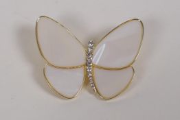 A gilt metal butterfly brooch with mother of pearl wings and cubic zirconia settings, 5 x 4cms