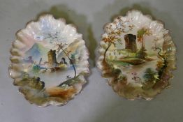 A pair of C19th ceramic wall plaques, hand painted with Scottish Highland views, 39cm long