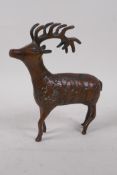 A middle eastern bronze figure of a stag, with figural decoration to the side, 15cm long