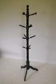 A Victorian ebonised wood coat stand, AF lacks one peg, 180cm high