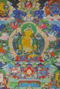 A Sino Tibetan printed thangka mounted within a silk border, 39 x 49cms