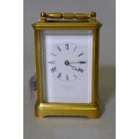 A brass carriage clock with bevelled glass, the enamel dial inscribed E.W. Streeter, 37 Conduit