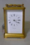 A brass carriage clock with bevelled glass, the enamel dial inscribed E.W. Streeter, 37 Conduit