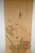 A Japanese watercolour scroll depicting a bird feeding her young nesting amongst bamboo, 43 x 91cms