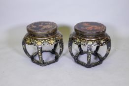 A matched pair of Chinese barrel shaped lacquered stands, with gilt decoration and pierced frieze,