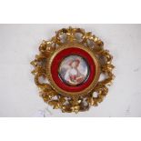 A miniature portrait on ivorine, in a carved and giltwood Florentine frame, 7cm diameter, frame 23cm