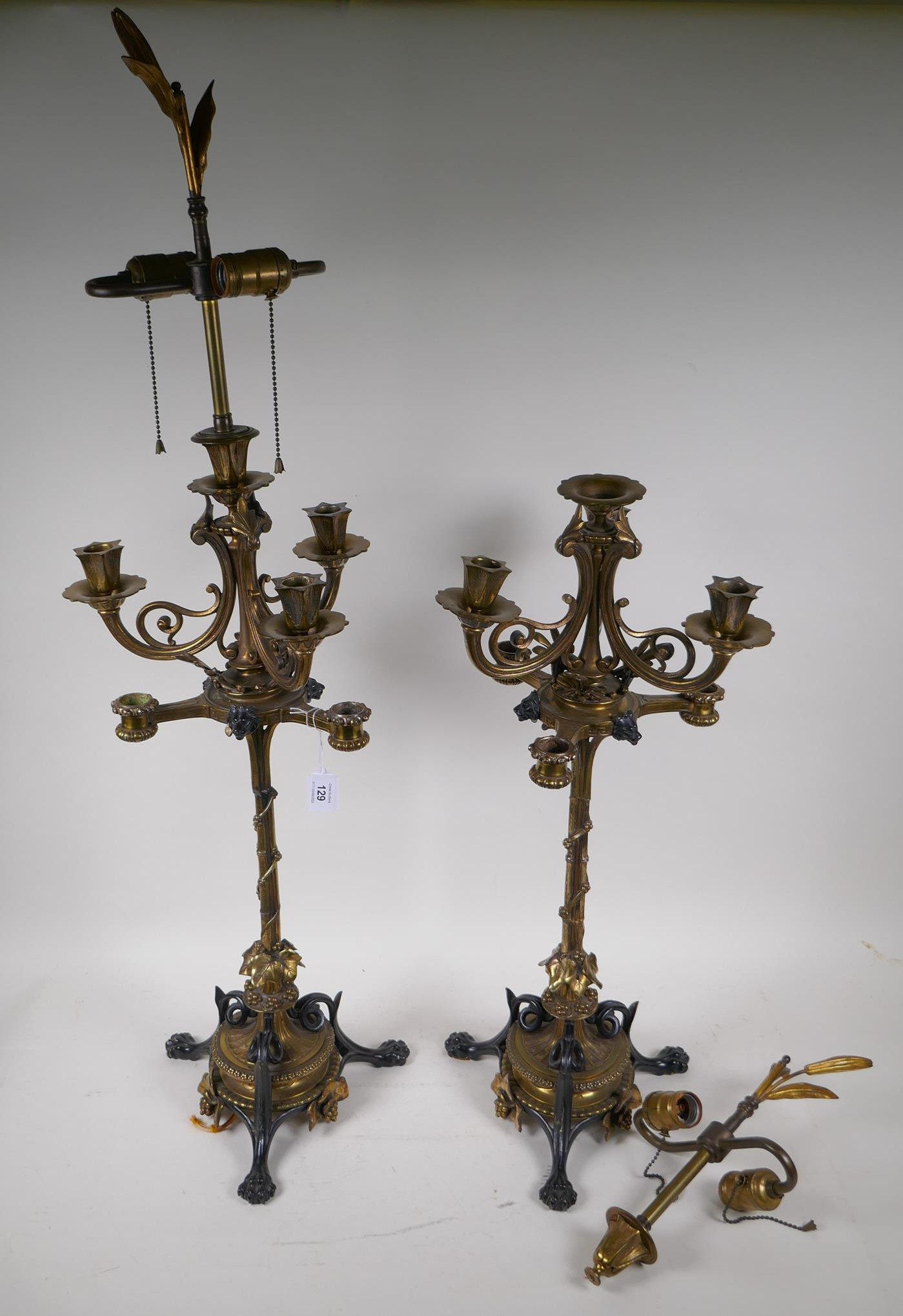 A pair of cold painted brass and three branch table lamps, with silver plated and ormolu detail,