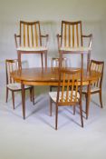 A 1960s G Plan Fresco teak extending dining table with a flip action centre piece, and six Sierra