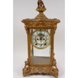 A vintage American gilt metal four glass mantel clock, the case embellished with female figures, the